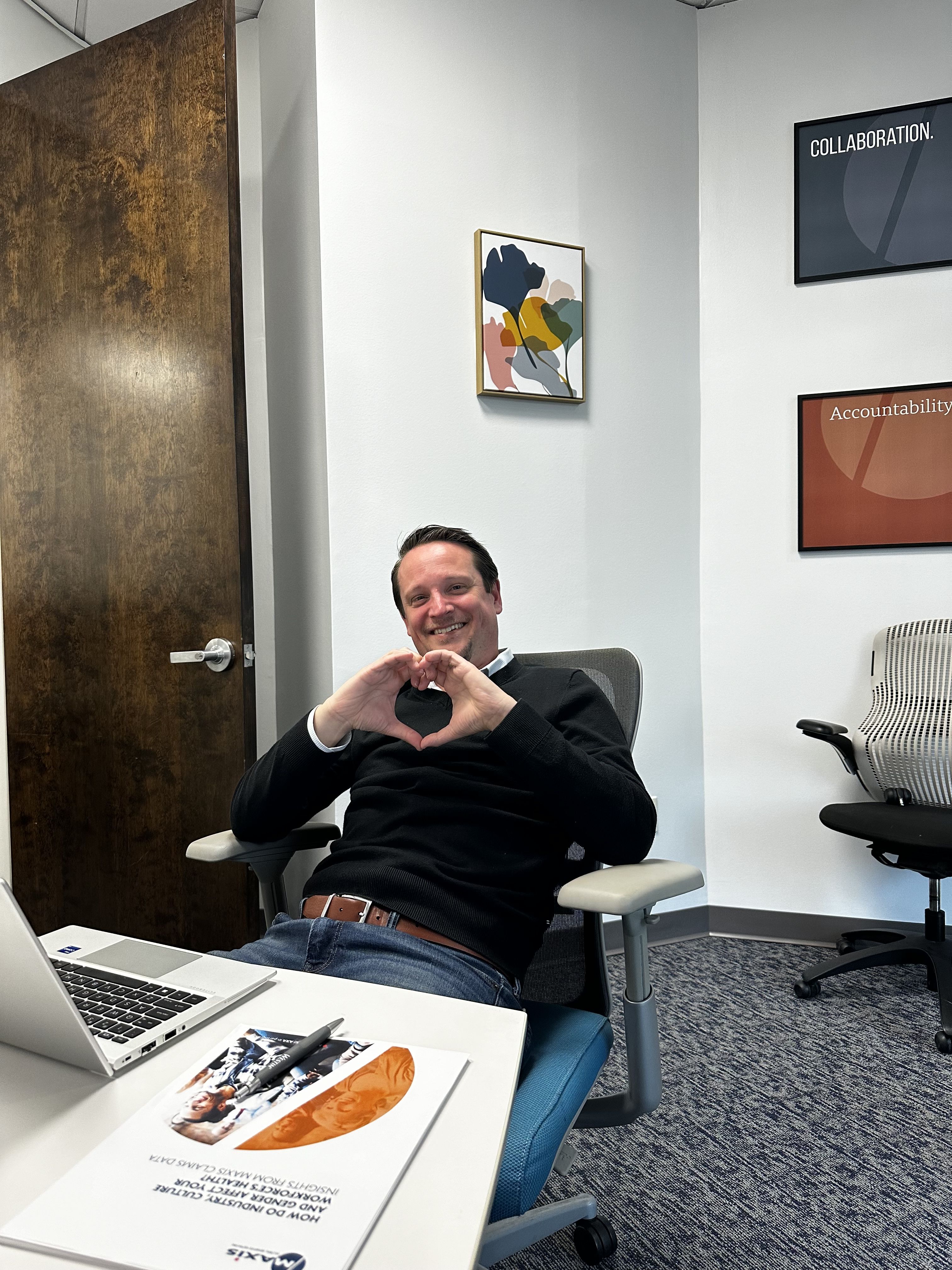 Paul Lewis showing his support for International Women's day with hands in the shape of a heart