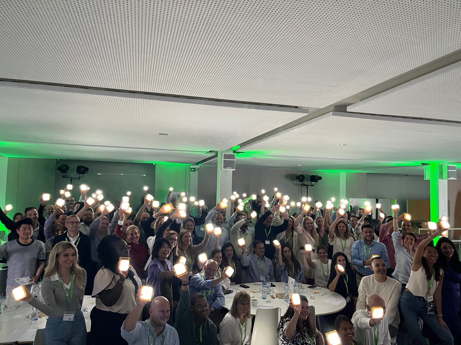 Global team with solar buddy inventions at the MAXIS Global Forum